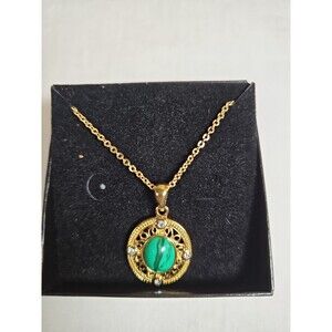 Gold tone necklace with green center